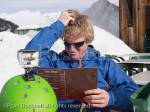 Man scratching his head whilst trying to decide what to 
eat from a menu in Gite du Lac de Gers ski restaurant. 
Sixt, Samoens, Haute Savoie, Rhone-Alpes, France, 
Europe. 