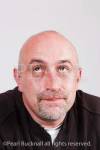 Portrait of a bald headed mature man looking upwards 
and thinking