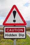 Triangular road sign warning Caution Hidden Dip with 
exclamation mark. South Uist, Scotland, UK, Britain, 
Europe