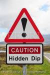 Triangular road sign warning Caution Hidden Dip with 
exclamation mark. South Uist, Scotland, UK, Britain, 
Europe
