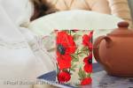 Morning mug of tea and teapot on a bedside table 
with a person sleeping in the bed. MR 11/14