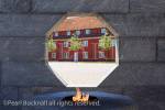Eternal flame with barracks seen through octagonal 
window in granite wall in Danish National Monument 
of Remembrance, Princess Bastion in Kastellet or 
Frederikshavn Citadel Copenhagen, Zealand, Denmark, 
Scandinavia, Europe