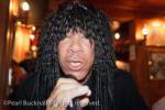 Black entertainer with dreadlocks singing into a 
microphone in The Underground apres ski bar in St 
Anton Austria