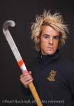 Head and shoulders portrait of a young man with a 
determined expression wearing a hockey shirt and 
holding a stick

Keywords: studio people sport sportsman