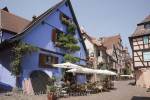 Riquewihr, Alsace, Haut-Rhin, France, Europe. 
Restaurant in old building on narrow cobbled street in 
picturesque medieval town on Alsatian wine route

Keywords: Europe French historic village town 
continental street cafe people travel