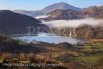 View to Llyn Gwynant lake and Yr Aran mountain with 
mist in the valley in Snowdonia National Park. Nant 
Gwynant, Gwynedd, North Wales, UK, Britain