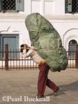 PORTER CARRYING LOAD SHERPA STYLE past part of 
Old Palace complex in Basantapur Square. Kathmandu 
Nepal Asia
