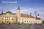 Roman Catholic church of the Holy Trinity and old 
buildings in Piata Mare pedestrianised square in 
historic city of Hermannstadt. Sibiu Transylvania 
Romania Europe
