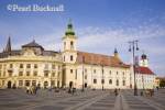 Roman Catholic church of the Holy Trinity and old 
buildings in Piata Mare pedestrianised square in 
historic city of Hermannstadt. Sibiu Transylvania 
Romania Europe

