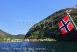 Norwegian flag on sightseeing boat on Mofjorden 
leaving the pretty village of Mo, Modalen ,Hordaland, 
Norway, Scandinavia, Europe