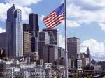 Downtown skyline from Pier 66 with the Stars and 
Stripes flag and city buildings. Seattle Washington 
State USA North America. 