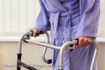 Elderly senior woman using a walker for support 
walking. England, UK, Britain, Europe. MR 13/32