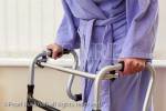 Elderly senior woman using a walker for support 
walking. England, UK, Britain, Europe. MR 13/32