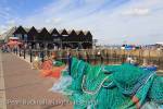 Harbour scene with colourful fishing nets on the quay 
on north Kent coast and Thames estuary in Whitstable, 
Kent, England, UK, Britain, Europe. 