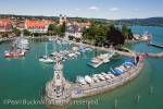 Aerial view of boats in the harbour with Bavarian Lion 
statue at entrance on Lake Constance (Bodensee) 
Lindau, Bavaria, Germany, Europe.