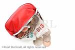 Red money purse containing ten and five pound notes 
with some coins spilling out

Studio still life sterling financial concept UK Britain 
British nobody