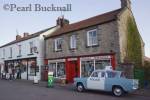 Aidensfield village shop with old Anglia police car 
parked as used in Heartbeat TV drama.  Goathland 
North Yorkshire Moors National Park England UK 
Europe

Keywords: tourism village filmset