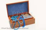 Wooden jewellery box containing jewels and trinkets 
isolated on a white background.