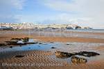 View along empty sandy beach to snow on the 
headland at low tide in winter. Benllech, Isle of 
Anglesey, North Wales, UK, Europe. 

Keywords: coast scene Britain British Welsh Ynys Mon