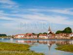 BOSHAM CREEK in Chichester harbour with the village 
and church reflected in still water. Bosham West Sussex 
England UK Britain

Keywords: Britain south coast picturesque village 
scenic