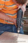 Man drilling into wood with an electric power drill 
power tool. England UK Britain  