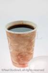 Disposable coffee cup full of black coffee on a white 
background

Studio still life product drink beverage nobody
