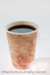 Disposable coffee cup full of black coffee on a white 
background

Studio still life product drink beverage nobody