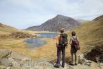 Cwm Idwal, North Wales, UK. Walkers by Llyn Idwal 
lake in the mountains of Snowdonia National Park.  

Keywords: hiking hike mountain walk men hikers 