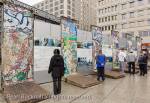 Tourists reading tourist information by sections of the 
wall with murals in Potsdamer Platz, Berlin, Germany, 
Europe. 