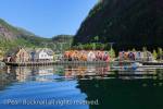 View along Mofjorden to to colourful buildings 
reflected in water in village of Mo, Modalen, 
Hordaland, Norway, Scandinavia, Europe