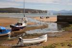Beached boats moored in the harbour at the mouth of 
Afon Soch River estuary at low tide. Abersoch, Lleyn 
Peninsula, Gwynedd, North Wales, UK. 