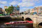 Sightseeing cruise boat passing under the O