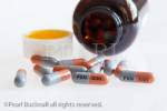 Pill bottle with Flucloxacillin 500 mg oral antibiotic 
capsules containing penicillin for treating bacterial 
infections, on a white background.