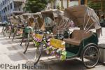 Row of rickshaw tricycles parked on street for tourist 
sightseeing tours. Chinatown Singapore Asia


