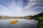 Scenic rural view with small wooden rowing boat 
reflected in calm water on River Dovey Afon Dyfi 
Glandyfi Ceredigion Mid Wales UK 

Keywords: calm landscape tranquil scene winter Britain 
British Welsh