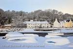 Snow scene with upturned boats on the coast in 
winter. Red Wharf Bay (Traeth Coch), Isle of 
Anglesey, North Wales, UK, Europe
