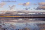 Tidal pool reflecting clouds on mountains of 
Snowdonia on Traeth Llanddwyn conservation beach  
Newborough Anglesey North Wales UK 

Keywords: beach coast landscape nobody scenic sea 
water